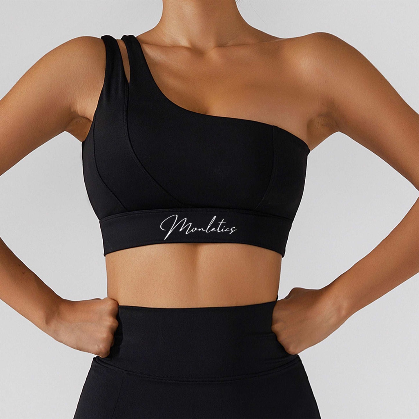 Monletics- black one shoulder sports bra facing forward, product picture